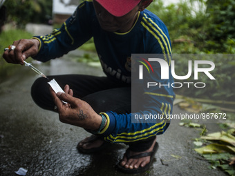 A junkies man, Dicky (33) and Hadi (42) where people live with HIV using the injection drug substitute for heroin addiction roadside in Meda...