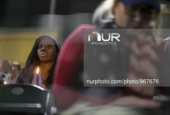 (151204)-- SAN BERNARDINO, Dec. 4, 2015 ()-- People attend a vigil to pray for the victims of a mass shooting at the San Manuel Stadium in S...