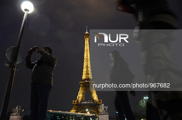 people walking in front of The Eifel Tower in Paris, France, on December 11, 2015 