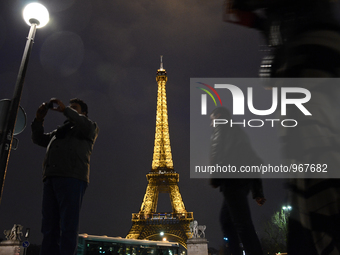 people walking in front of The Eifel Tower in Paris, France, on December 11, 2015 (