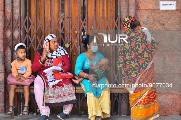 Mothers are seen in queue with their children in front of a fever clinic at a government run hospital in Kolkata , India , on 2 March 2023 ....