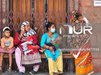 Mothers are seen in queue with their children in front of a fever clinic at a government run hospital in Kolkata , India , on 2 March 2023 ....