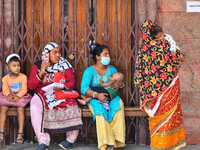 Mothers are seen in queue with their children in front of a fever clinic at a government run hospital in Kolkata , India , on 2 March 2023 ....