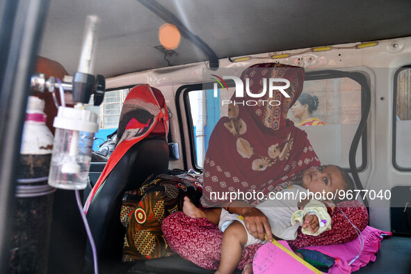 A children suffering from respiratory infection is seen wearing a oxygen tube as he waits for treatment at a government run hospital in Kolk...