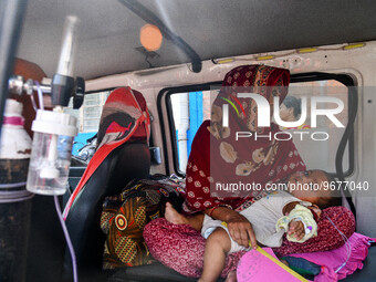 A children suffering from respiratory infection is seen wearing a oxygen tube as he waits for treatment at a government run hospital in Kolk...