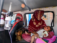 A children suffering from respiratory infection is seen wearing a oxygen tube as he waits for treatment at a government run hospital in Kolk...