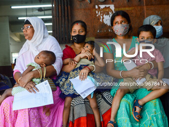 

Mothers are seen waiting with their children in front of a fever clinic at a government-run children's hospital in Kolkata, India, on Marc...