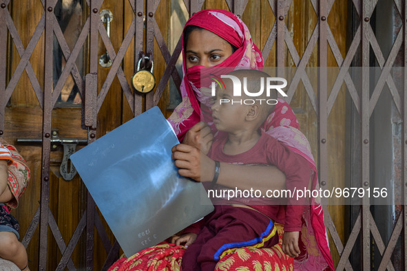 

A woman is holding the x-ray of her son, who is suffering from respiratory problems, at a hospital in Kolkata, India, on March 3, 2023. Th...