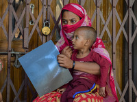 

A woman is holding the x-ray of her son, who is suffering from respiratory problems, at a hospital in Kolkata, India, on March 3, 2023. Th...