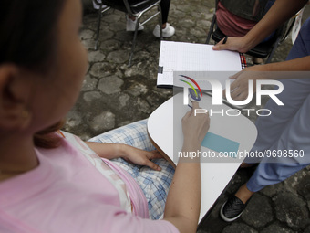 The committee checks the participant's blood pressure as they took part in the daydream competition which was held in Solo, Central Java, on...