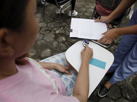 The committee checks the participant's blood pressure as they took part in the daydream competition which was held in Solo, Central Java, on...