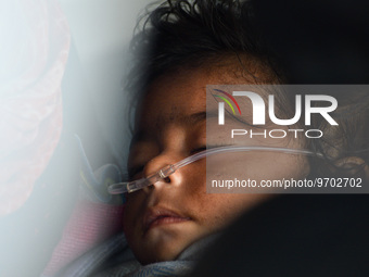 A five-month-old child, who is suffering from respiratory problems, is seen, inside an ambulance, at a hospital in Kolkata on March 06, 2023...