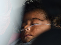 A five-month-old child, who is suffering from respiratory problems, is seen, inside an ambulance, at a hospital in Kolkata on March 06, 2023...