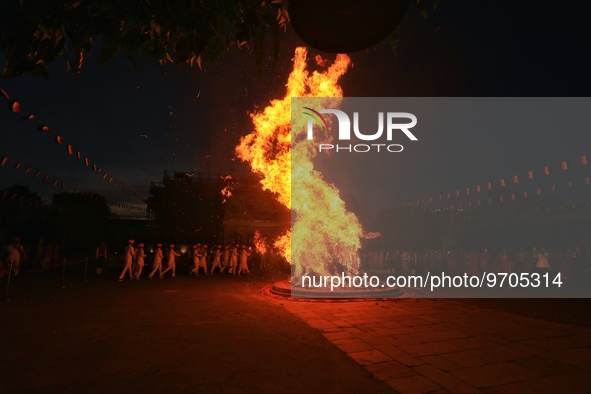 People performs rituals during 'Holika Dahan', at City Palace in Jaipur, Rajasthan,India, Monday, March 6, 2023. 