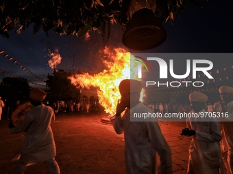 People performs rituals during 'Holika Dahan', at City Palace in Jaipur, Rajasthan,India, Monday, March 6, 2023. (