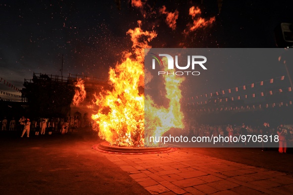 People performs rituals during 'Holika Dahan', at City Palace in Jaipur, Rajasthan,India, Monday, March 6, 2023. 