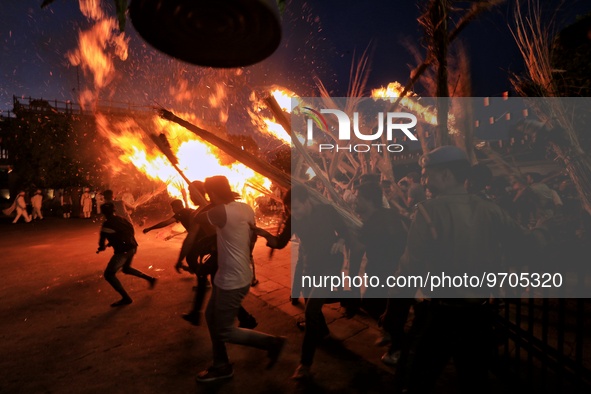 People performs rituals during 'Holika Dahan', at City Palace in Jaipur, Rajasthan,India, Monday, March 6, 2023. 