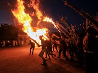 People performs rituals during 'Holika Dahan', at City Palace in Jaipur, Rajasthan,India, Monday, March 6, 2023. (
