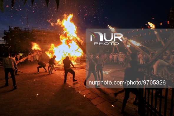 People performs rituals during 'Holika Dahan', at City Palace in Jaipur, Rajasthan,India, Monday, March 6, 2023. 