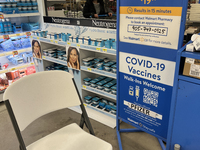 Sign at a Walmart store informing customers that they can get their COVID-19 vaccine or a COVID-19 antigen test  in Toronto, Ontario, Canada...