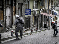 A Turkish protester throws a stone towards riot police during clashes that erupted as riot police began to disperse a May Day rally near Tak...