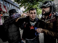 Riot police detain a leftist demonstrator during clashes in Istanbul, Turkey, Friday, May 1, 2014 Thousands of Turkish union workers held a...