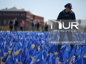 A man places flags at a visual exhibit organized by the Fight Colorectal Cancer organization on the National Mall in Washington, D.C. on Mar...