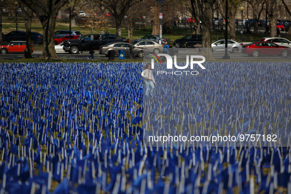 A young girl walks through a visual exhibit of flags organized by the Fight Colorectal Cancer organization on the National Mall in Washingto...