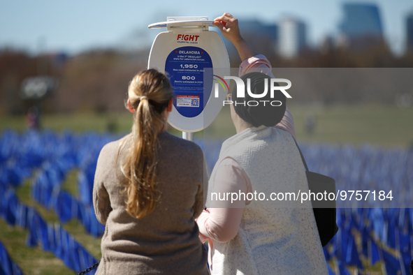 People view statistics at a visual exhibit organized by the Fight Colorectal Cancer organization on the National Mall in Washington, D.C. on...