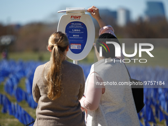 People view statistics at a visual exhibit organized by the Fight Colorectal Cancer organization on the National Mall in Washington, D.C. on...