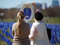 People view statistics at a visual exhibit organized by the Fight Colorectal Cancer organization on the National Mall in Washington, D.C. on...