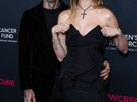 American singer and songwriter Adam Levine of American pop rock band Maroon 5 and wife/Namibian model Behati Prinsloo arrive at The Women's...