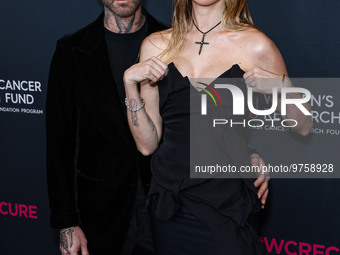 American singer and songwriter Adam Levine of American pop rock band Maroon 5 and wife/Namibian model Behati Prinsloo arrive at The Women's...