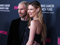 American singer and songwriter Adam Levine of American pop rock band Maroon 5 and wife/Namibian model Behati Prinsloo arrive at The Women's...