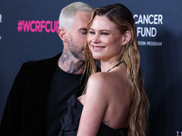 American singer and songwriter Adam Levine of American pop rock band Maroon 5 and wife/Namibian model Behati Prinsloo arrive at The Women's...