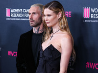 American singer and songwriter Adam Levine of American pop rock band Maroon 5 and wife/Namibian model Behati Prinsloo arrive at The Women's...