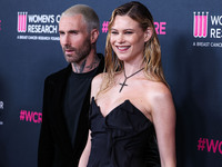 American singer and songwriter Adam Levine of American pop rock band Maroon 5 and wife/Namibian model Behati Prinsloo arrive at The Women's...