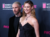 American singer and songwriter Adam Levine of American pop rock band Maroon 5 and wife/Namibian model Behati Prinsloo arrive at The Women's...