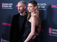 American singer and songwriter Adam Levine of American pop rock band Maroon 5 and wife/Namibian model Behati Prinsloo arrive at The Women's...