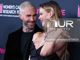 American singer and songwriter Adam Levine of American pop rock band Maroon 5 and wife/Namibian model Behati Prinsloo arrive at The Women's...