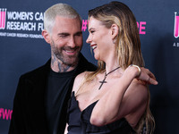 American singer and songwriter Adam Levine of American pop rock band Maroon 5 and wife/Namibian model Behati Prinsloo arrive at The Women's...