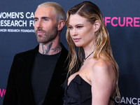 American singer and songwriter Adam Levine of American pop rock band Maroon 5 and wife/Namibian model Behati Prinsloo arrive at The Women's...