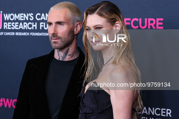 American singer and songwriter Adam Levine of American pop rock band Maroon 5 and wife/Namibian model Behati Prinsloo arrive at The Women's...