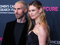 American singer and songwriter Adam Levine of American pop rock band Maroon 5 and wife/Namibian model Behati Prinsloo arrive at The Women's...