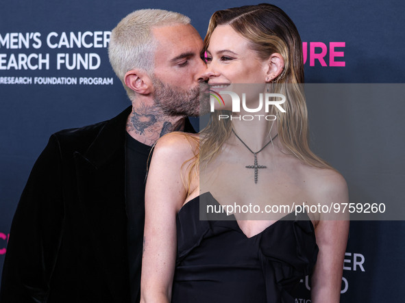 American singer and songwriter Adam Levine of American pop rock band Maroon 5 and wife/Namibian model Behati Prinsloo arrive at The Women's...