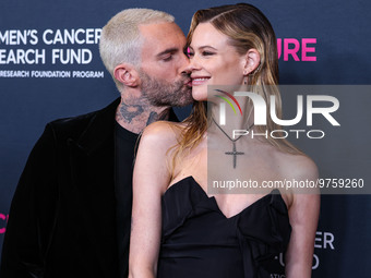 American singer and songwriter Adam Levine of American pop rock band Maroon 5 and wife/Namibian model Behati Prinsloo arrive at The Women's...