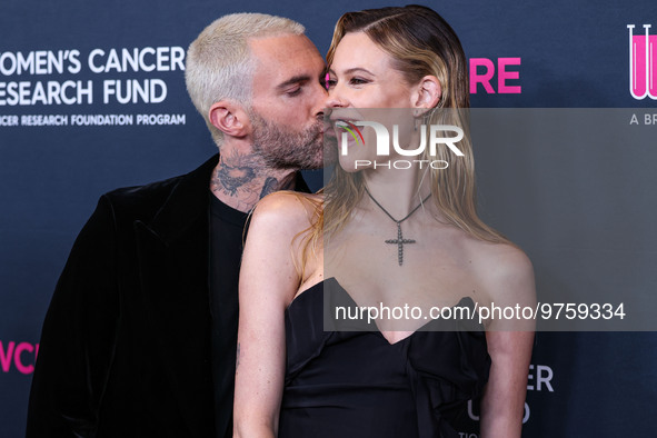 American singer and songwriter Adam Levine of American pop rock band Maroon 5 and wife/Namibian model Behati Prinsloo arrive at The Women's...