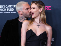 American singer and songwriter Adam Levine of American pop rock band Maroon 5 and wife/Namibian model Behati Prinsloo arrive at The Women's...