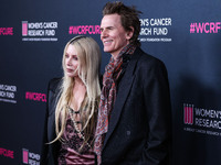 Gela Nash-Taylor and husband/British musician John Taylor of English rock band Duran Duran arrive at The Women's Cancer Research Fund's An U...