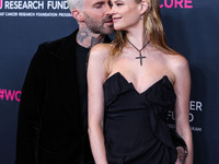 American singer and songwriter Adam Levine of American pop rock band Maroon 5 and wife/Namibian model Behati Prinsloo arrive at The Women's...